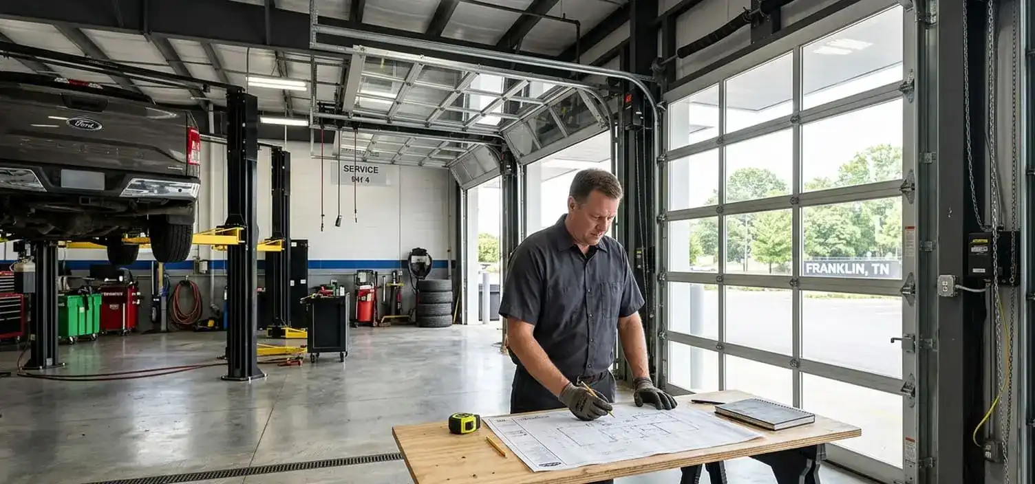 Auto shop bay door installed at a service centre in Franklin Tennessee with overhead clearance for vehicle lifts